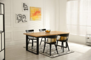 Stylish wooden dining table and chairs in room. Interior design